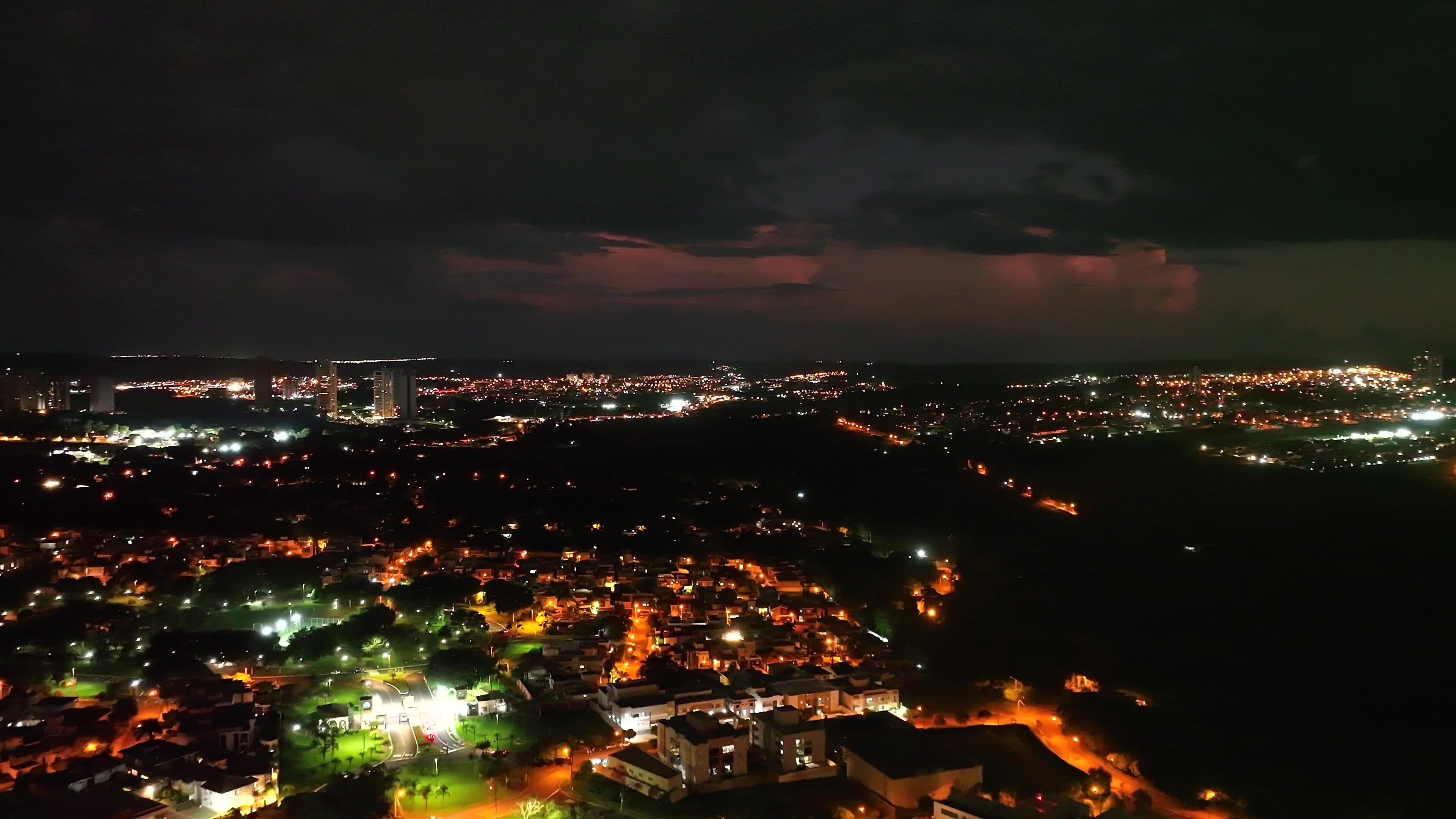 night flight over the city with sequential lightning in the sky